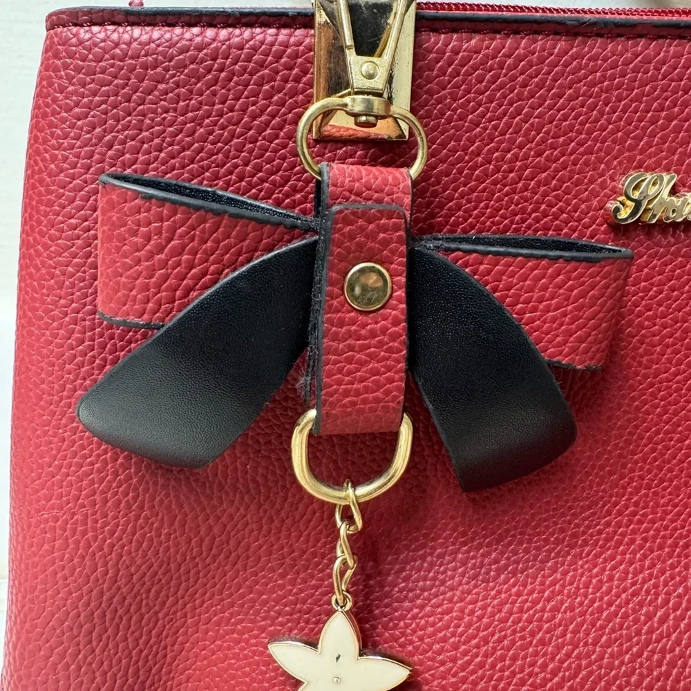 Charming Red Satchel with Bow by [Brand]